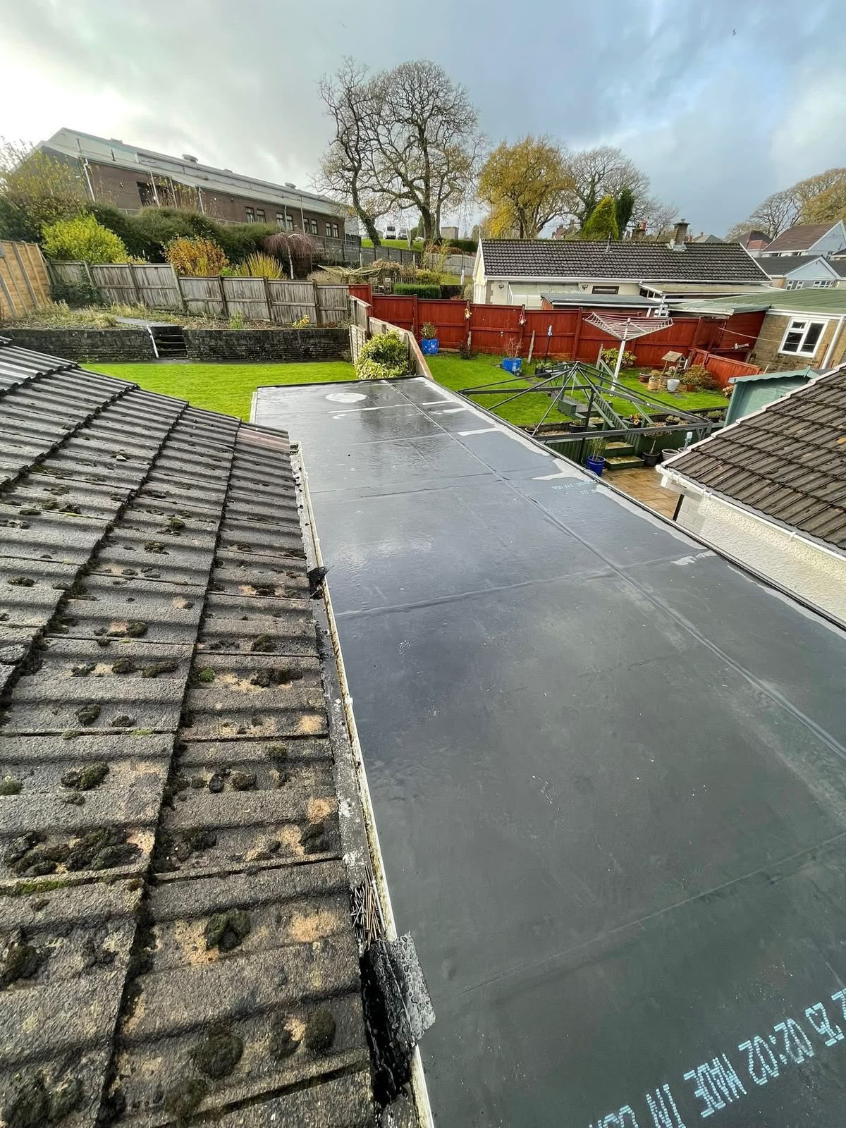 Flat roof repairs Glasgow: completed EPDM flat roof on a rear extension